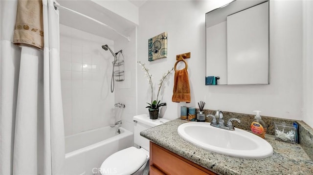 full bathroom featuring toilet, tiled shower / bath, and vanity