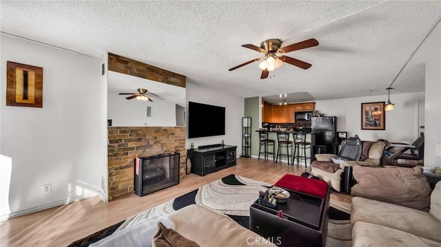 6435 Green Valley Cir Unit 214, Culver City, CA 90230 - living area with ceiling fan, light wood-type flooring, and a textured ceiling