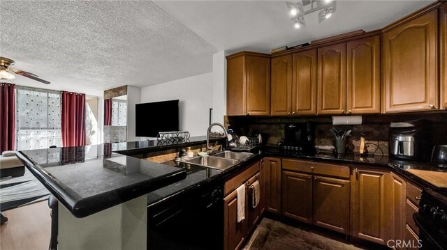 6435 Green Valley Cir Unit 214, Culver City, CA 90230 - kitchen with black dishwasher, a peninsula, decorative backsplash, a ceiling fan, and stove