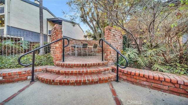 view of gate featuring a patio and fence