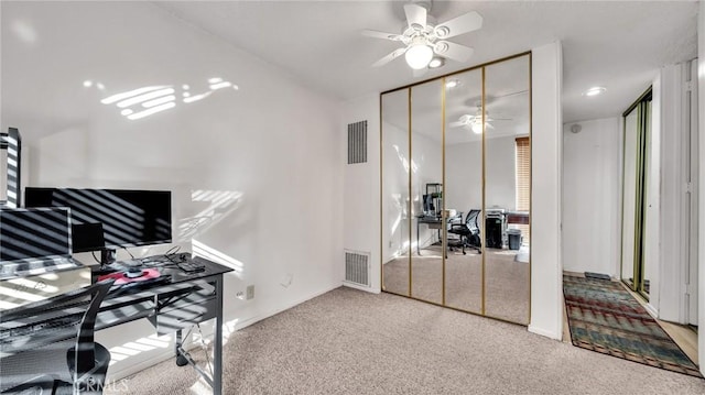 office featuring carpet, visible vents, and ceiling fan