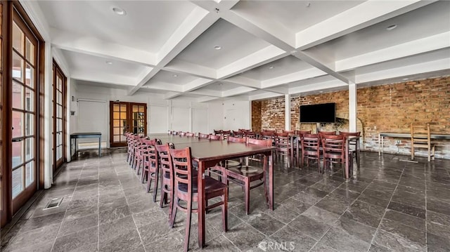 dining room with brick wall, french doors, beamed ceiling, and coffered ceiling