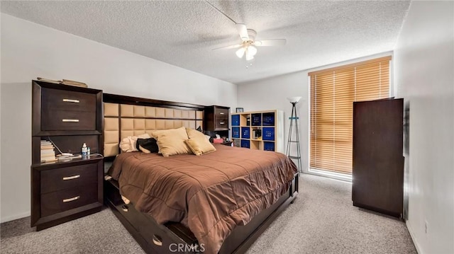 bedroom featuring light carpet, ceiling fan, and a textured ceiling