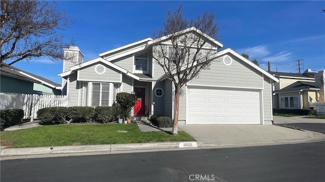 view of property with a garage and a front lawn