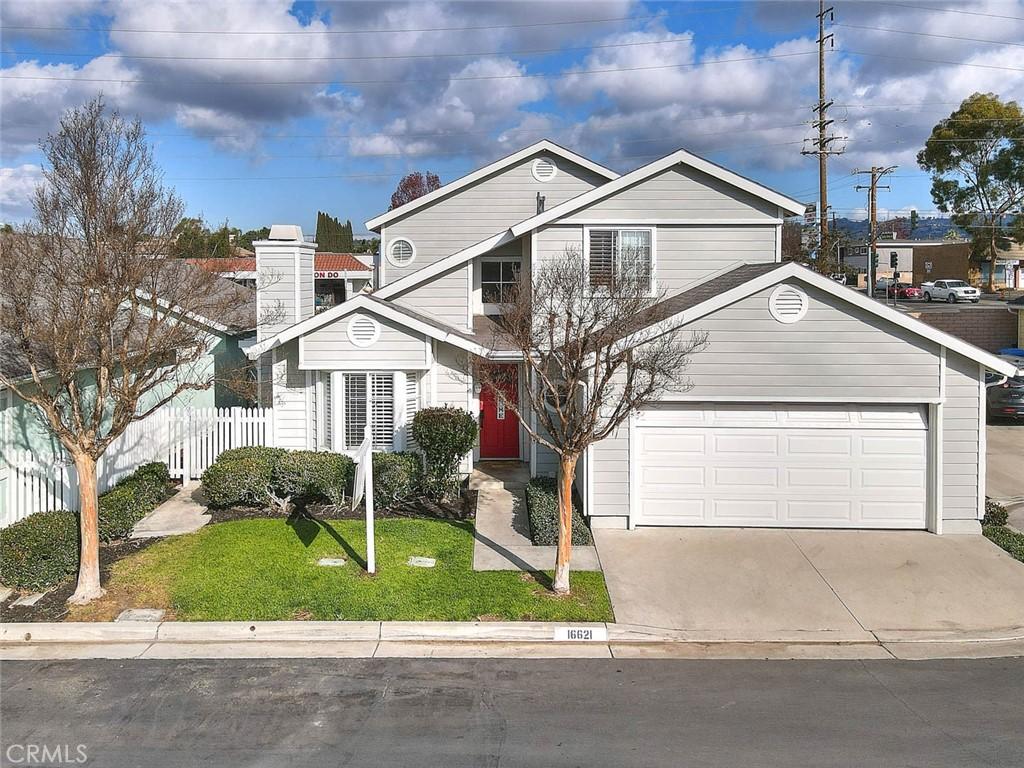 view of property featuring a front lawn and a garage