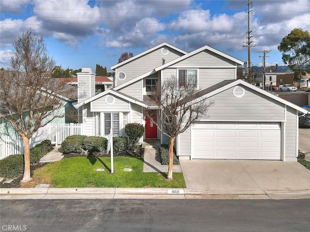 view of property featuring a front lawn and a garage