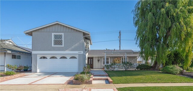 view of property with a garage and a front yard