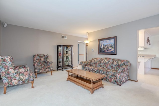 living room with visible vents and light carpet