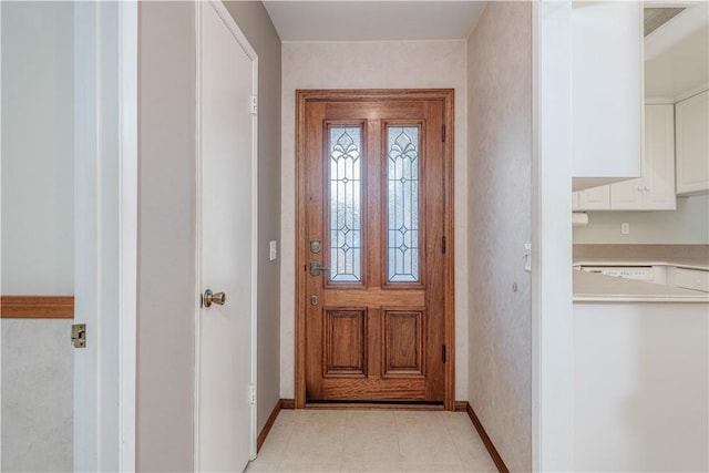 foyer featuring baseboards