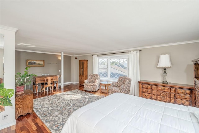 bedroom featuring baseboards, wood finished floors, and crown molding