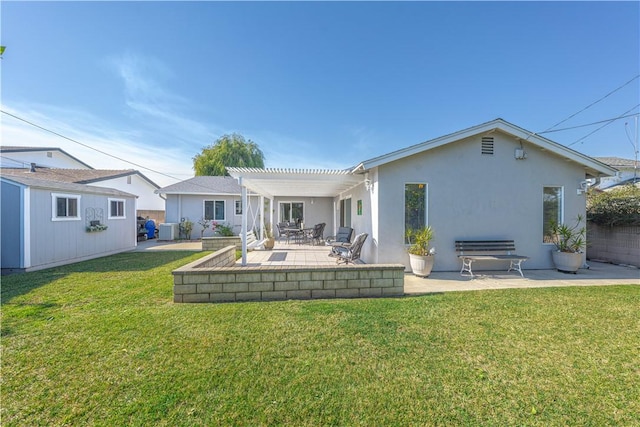 back of house featuring a patio, central AC, a lawn, stucco siding, and a pergola