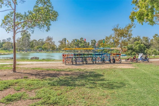 view of community with a water view and a lawn