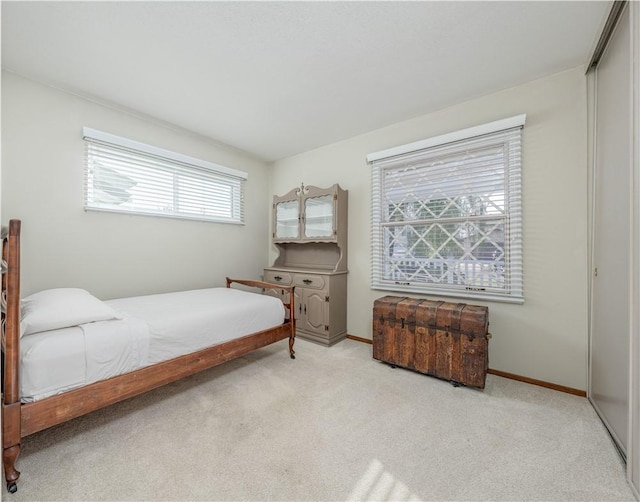 bedroom featuring carpet floors, baseboards, and a closet