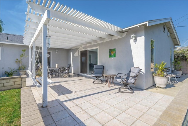 view of patio featuring outdoor dining area and a pergola