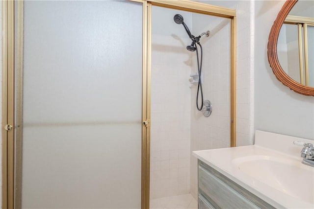 bathroom featuring a shower stall and vanity