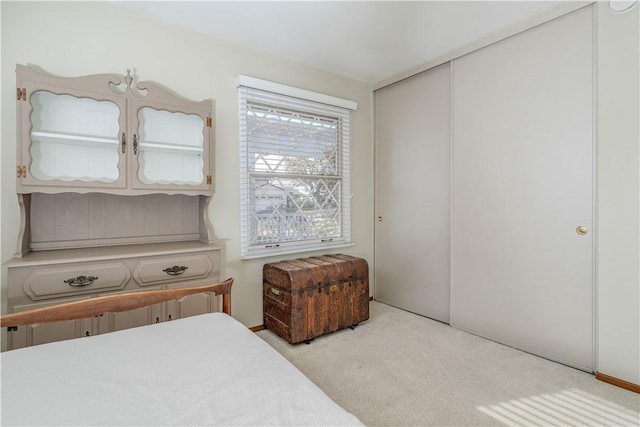 carpeted bedroom featuring a closet