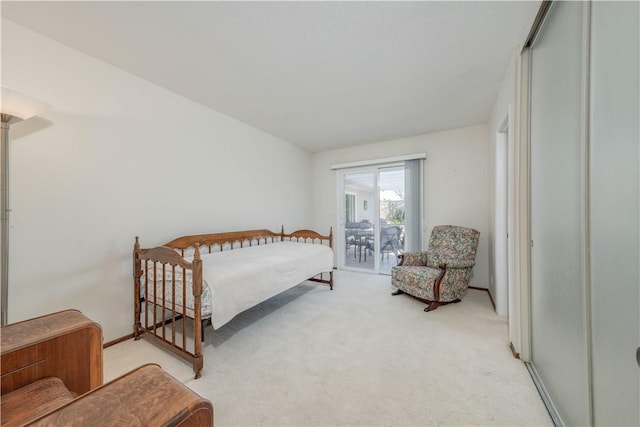 bedroom featuring access to outside and light carpet