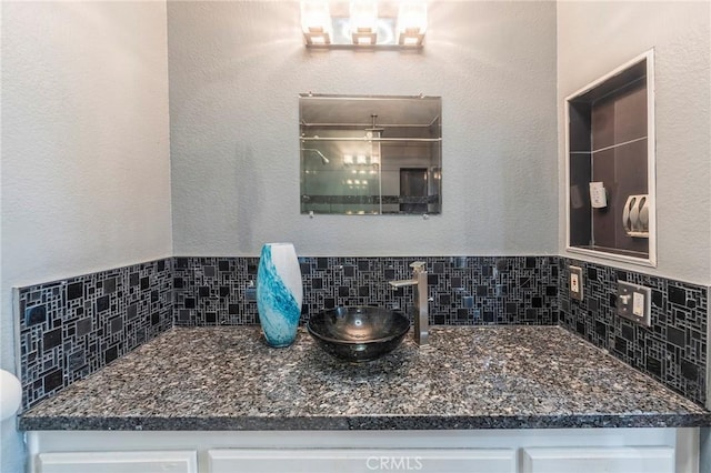 bathroom with vanity and decorative backsplash