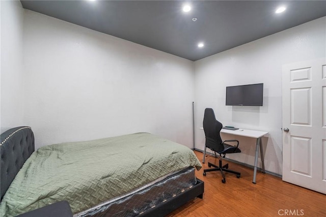 bedroom with hardwood / wood-style floors