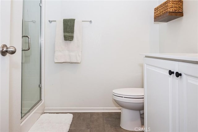 bathroom featuring tile patterned floors, toilet, vanity, and walk in shower