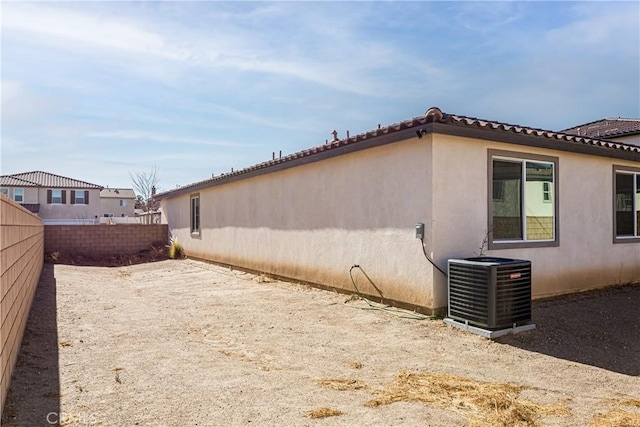 view of home's exterior with central AC unit