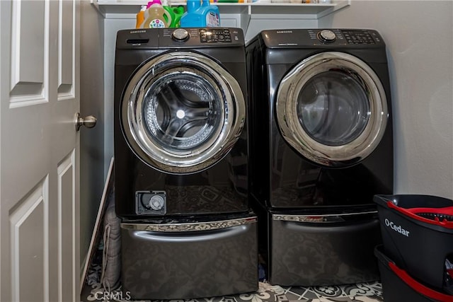 clothes washing area featuring separate washer and dryer