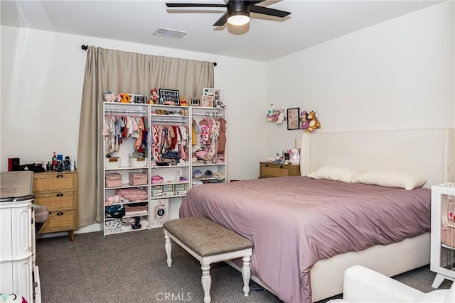 bedroom featuring dark carpet and ceiling fan