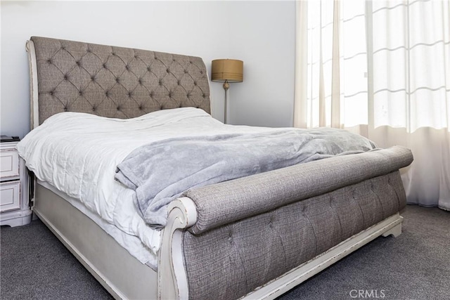 carpeted bedroom featuring multiple windows