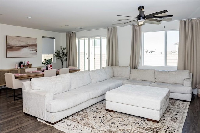 living room featuring hardwood / wood-style floors and ceiling fan