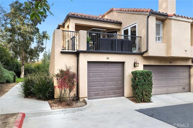 view of front of house featuring a balcony and a garage