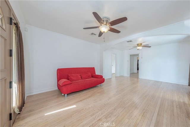 sitting room with a ceiling fan, baseboards, visible vents, and light wood-type flooring