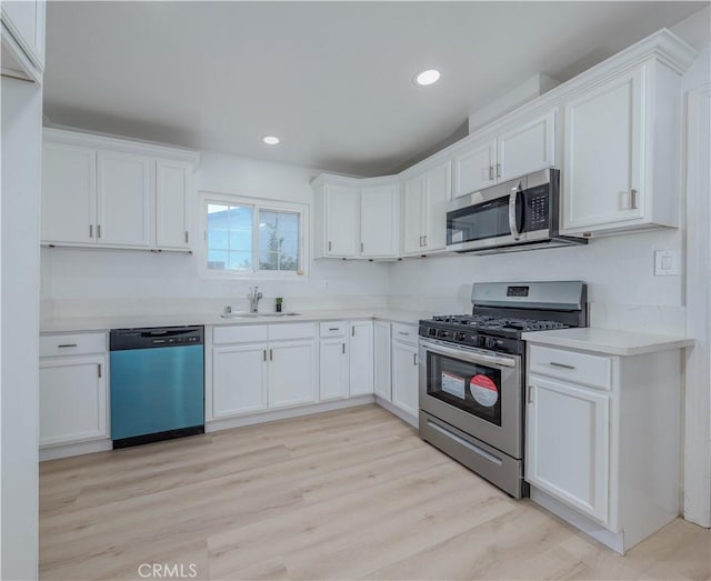 kitchen featuring white cabinetry, appliances with stainless steel finishes, and light countertops