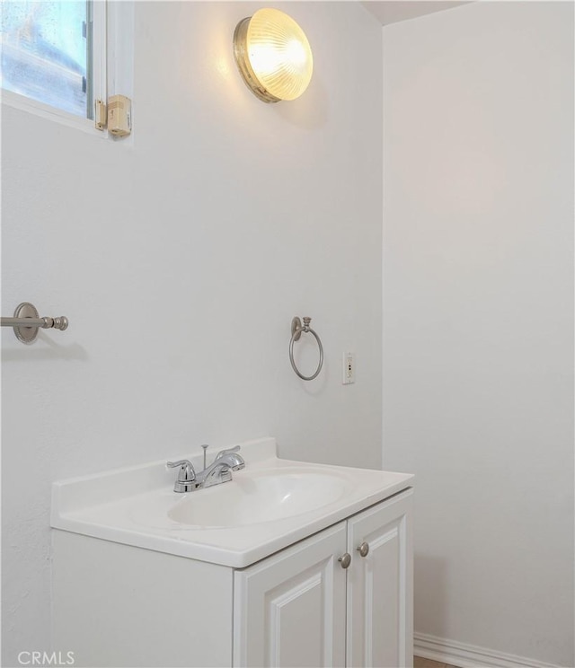 bathroom featuring baseboards and vanity