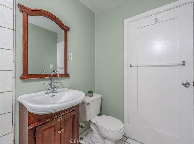 bathroom with vanity, toilet, and tile patterned flooring