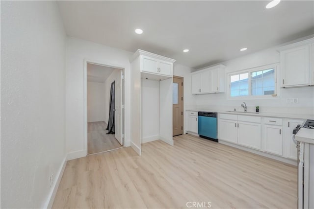 kitchen featuring light wood-type flooring, a sink, recessed lighting, white cabinets, and dishwashing machine