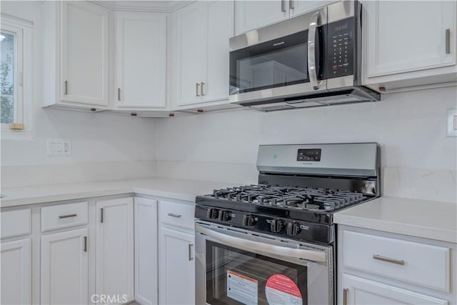 kitchen featuring light countertops, white cabinets, and appliances with stainless steel finishes