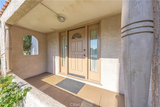 entrance to property featuring stucco siding