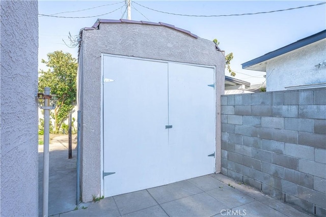 view of shed featuring fence