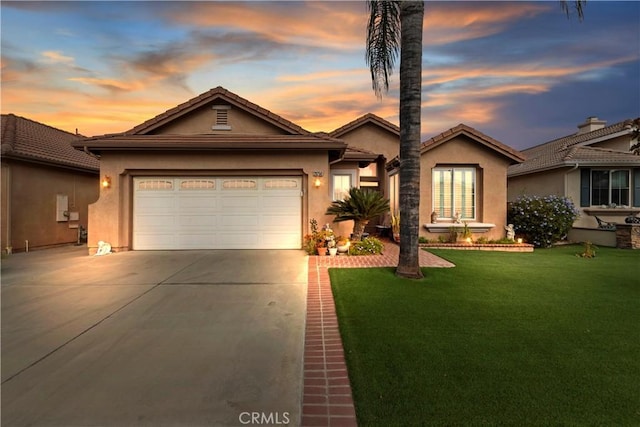 view of front of house with a garage and a yard