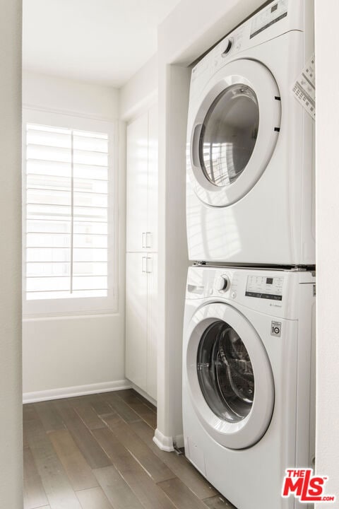 laundry area with stacked washing maching and dryer