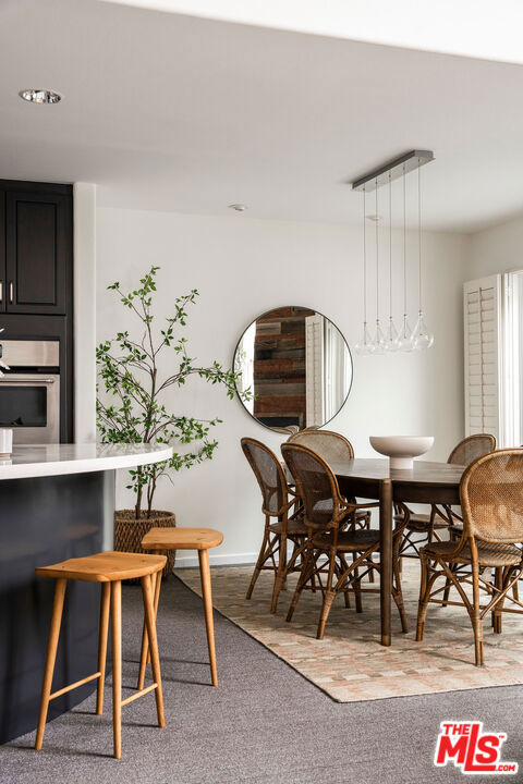 dining room featuring light carpet