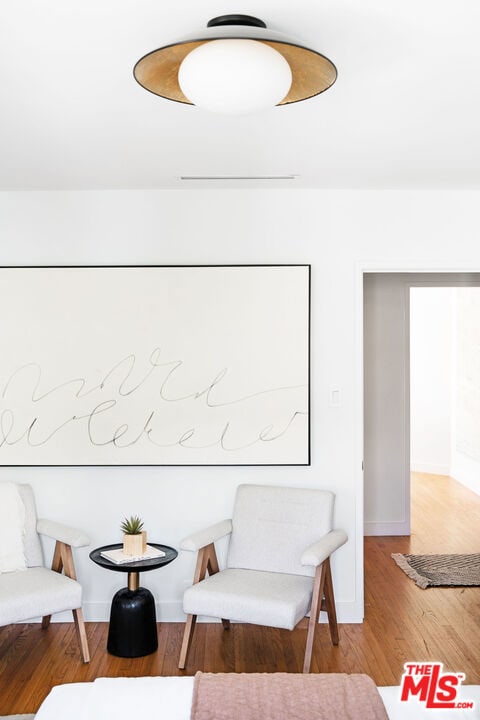 living area with hardwood / wood-style flooring