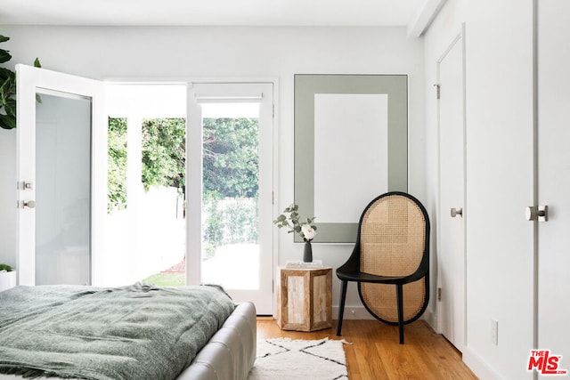 bedroom featuring light hardwood / wood-style flooring and multiple windows