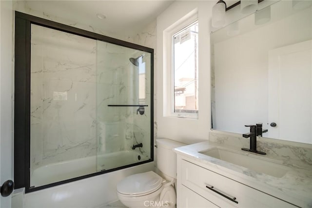 full bathroom with vanity, toilet, and combined bath / shower with glass door