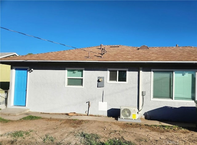 back of house with ac unit