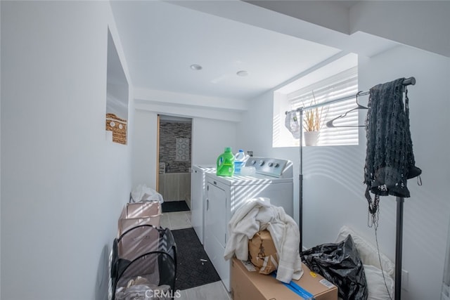 washroom with independent washer and dryer and light tile patterned floors