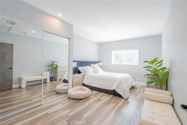 bedroom featuring hardwood / wood-style floors and a closet