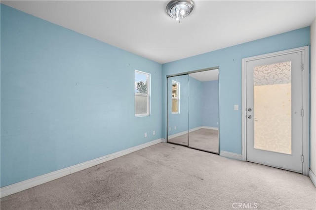 unfurnished bedroom featuring light colored carpet