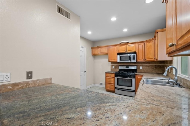 kitchen featuring sink, stainless steel appliances, and tasteful backsplash