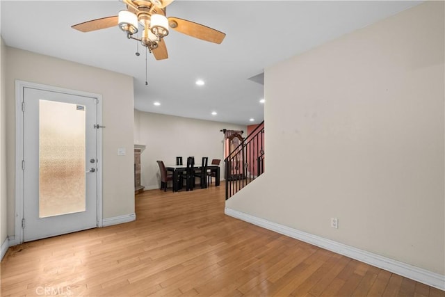 foyer featuring ceiling fan and light hardwood / wood-style flooring